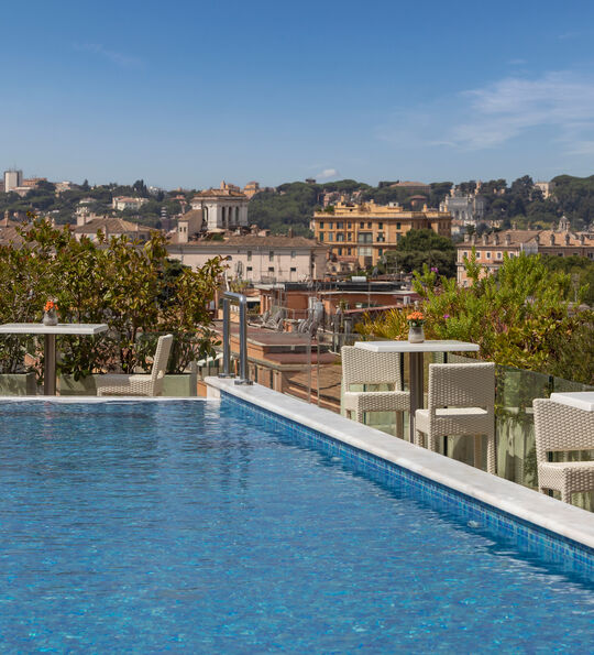 The rooftop pool and view across the city from the Anantara Palazzo Naiadi Rome