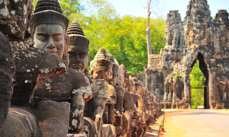 Statues lining the route to one of the main gates at Angkor Wat, Cambodia