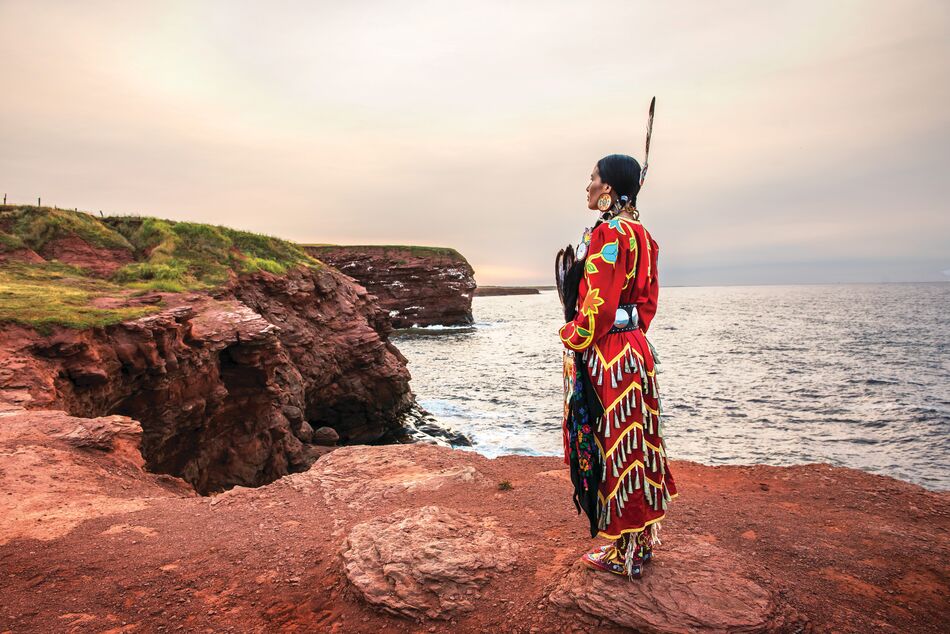Mi'kmaq woman on a cliff overlooking the sea at Cape Tryon, Prince Edward Island