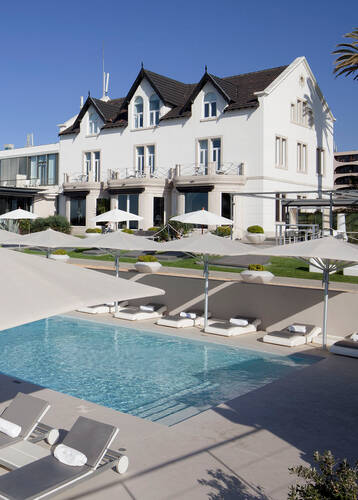 Swimming pool and the exterior of Farol Hotel, Cascais