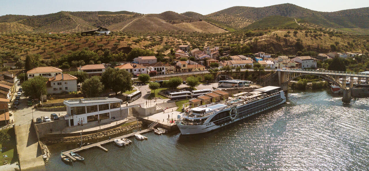Tauck's MS Andorinha in Portugal's Douro Valley with the river in the foreground surrounded by terraced vineyards