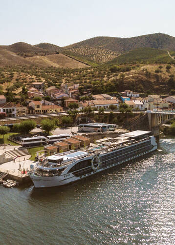 Tauck's MS Andorinha in Portugal's Douro Valley with the river in the foreground surrounded by terraced vineyards