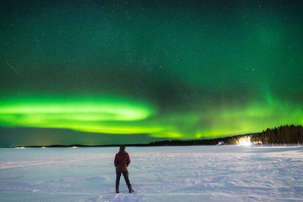 Northern Lights over a frozen lake near Rovaniemi, Finnish Lapland