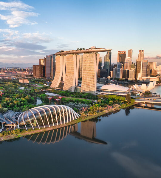 Aerial view of Singapore, including Supertrees and Marina Bay.