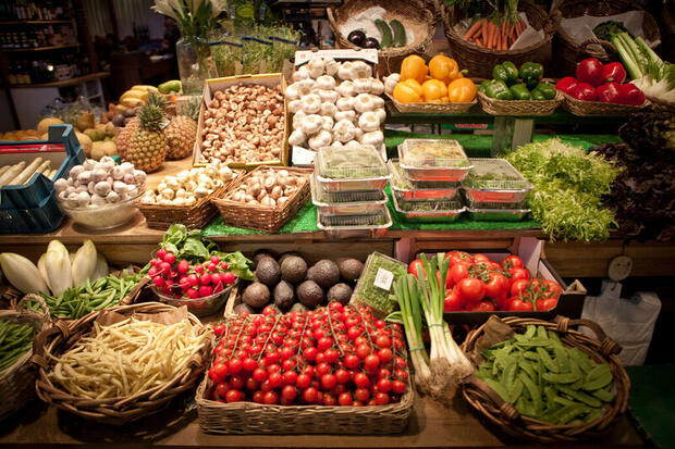 Colourful fresh produce on a market stall at Östermalms Saluhall